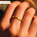 Gold ring on a person's finger with 'Best Seller' label